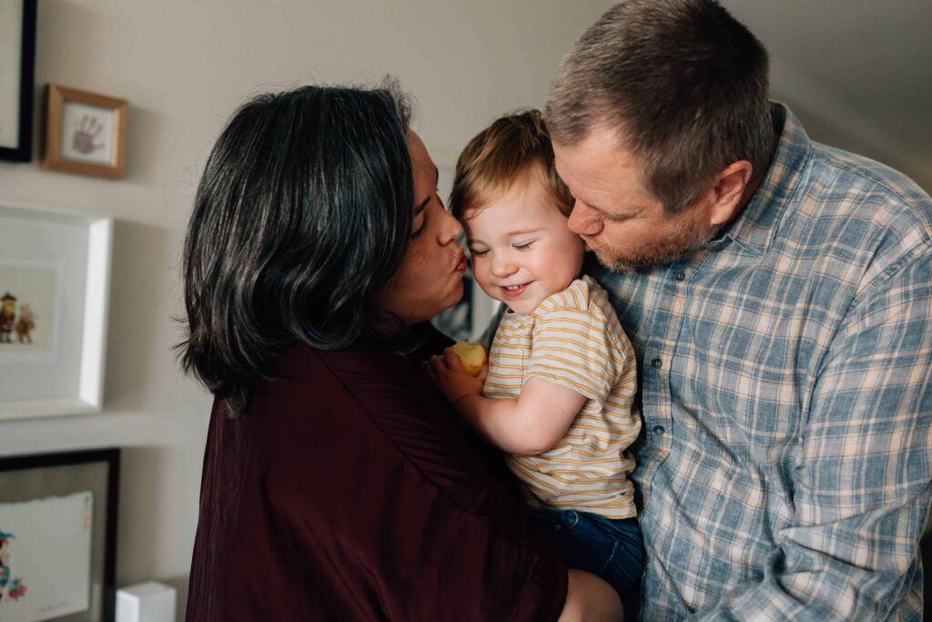 boy gets double kisses from Mum and Dad, value of photography, especially plus size family photos