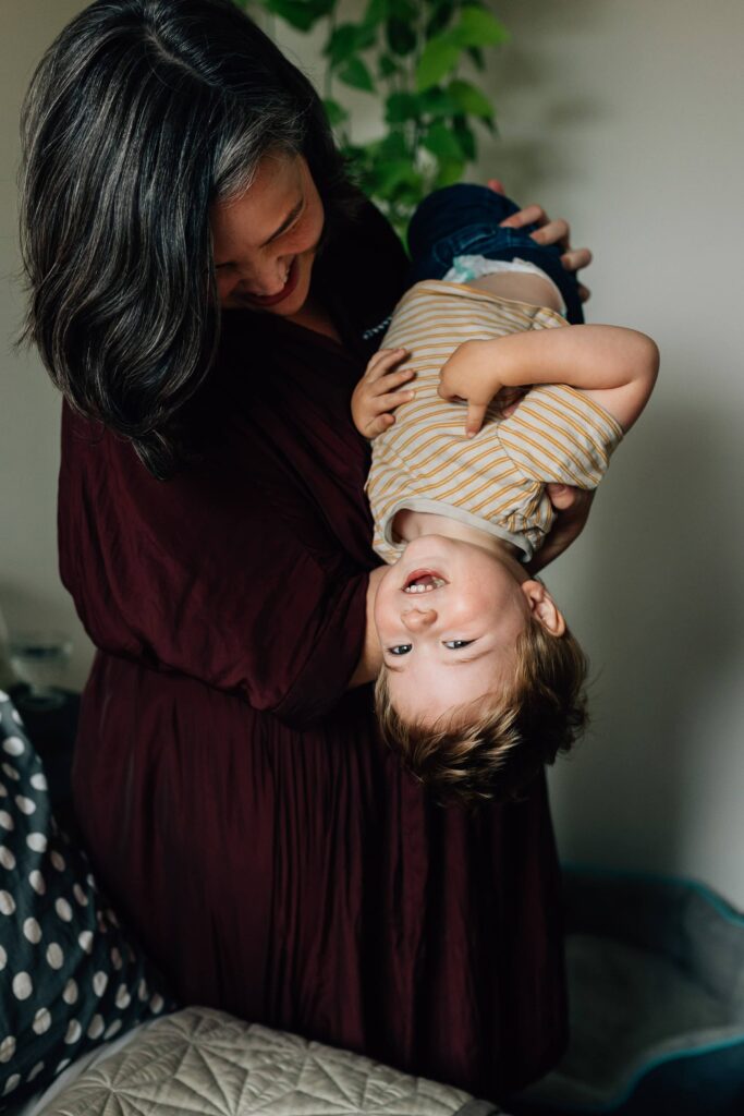 Mum holding boy upside down, value of photography, especially plus size family photos