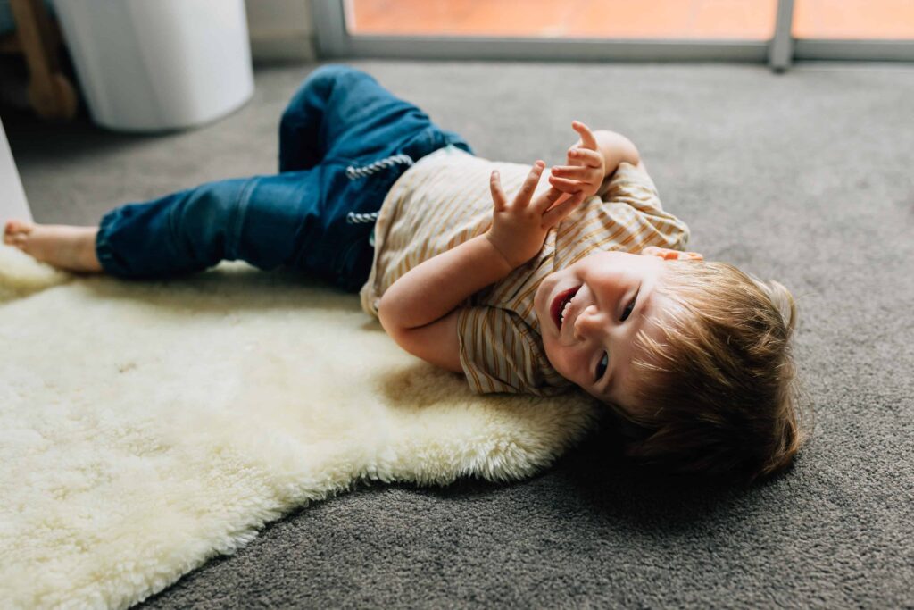 boy laying on floor and laughing