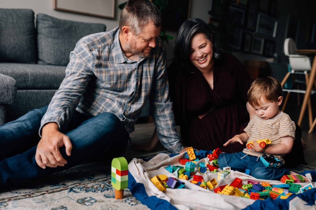 Mum, Dad and boy sitting on floor and playing Duplo, value of photography, especially plus size family photos