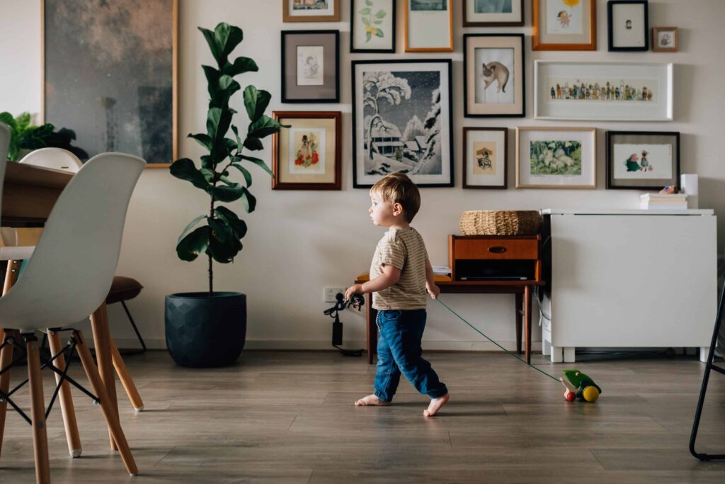 boy pulling frog toy as he walks in house, value of photography, especially plus size family photos
